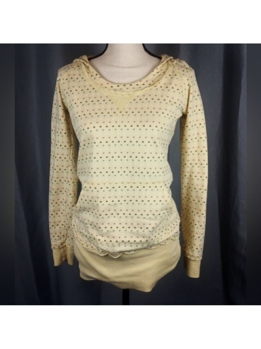 Yellow hooded sweatshirt with pink, purple, and blue heart pattern, size M